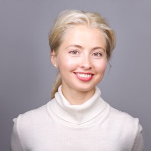 Kirstin Boncher, Boca Raton photographer, smiling in white turtleneck